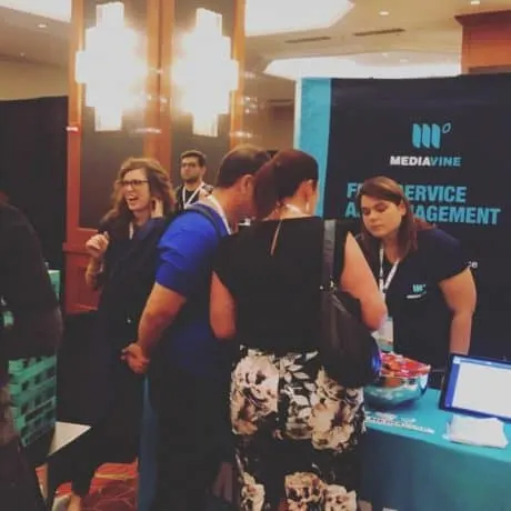 Amber Bracegirdle, Mediavine cofounder, speaking with FinCon attendees at the Mediavine booth.