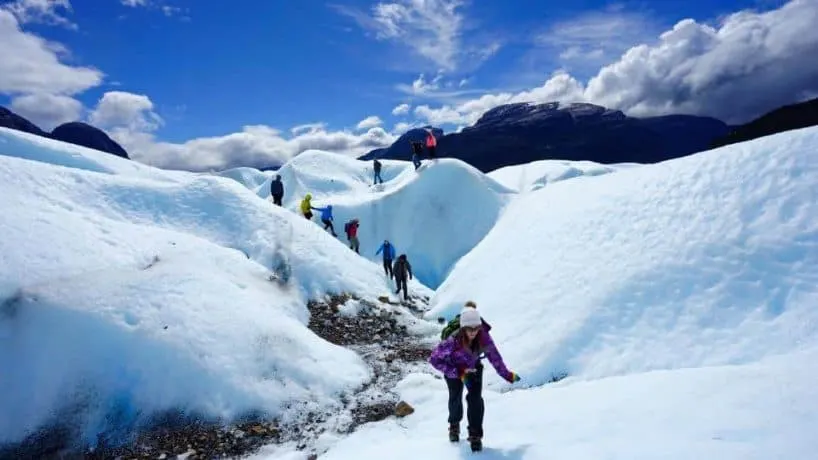 Kristin Addis hikes over snow and ice.