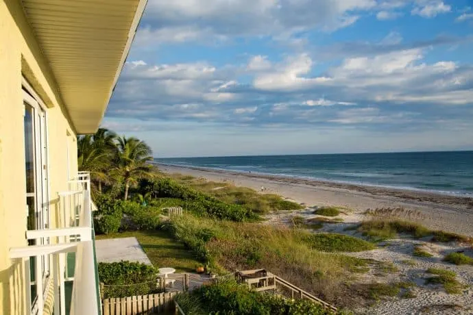 A view of the beach from a yellow house.