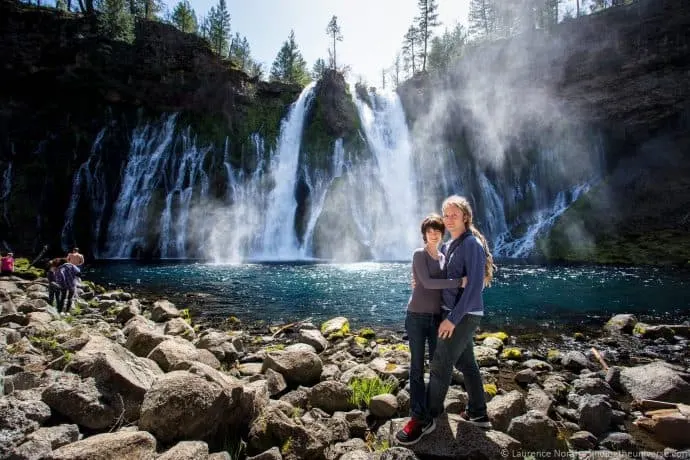 Laurence Norah and his wife, Jessica, stand in front of a waterfall.