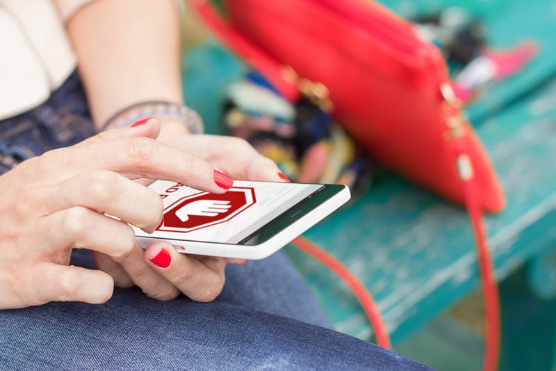 Woman using cell phone with bad ad experience.