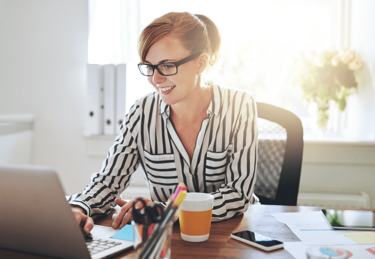 A woman types at a laptop computer.