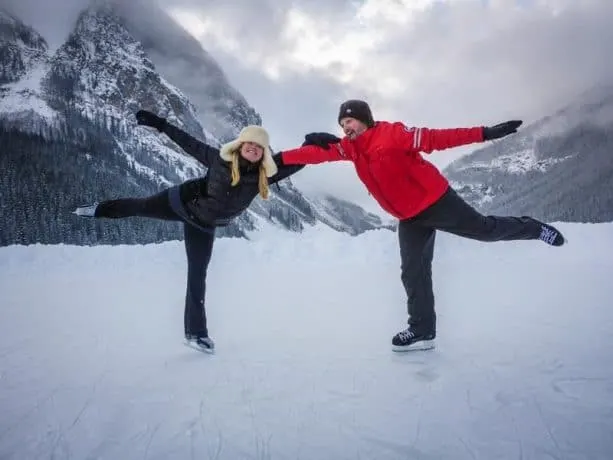 Deb and Dave ice skating together on a mountain lake.