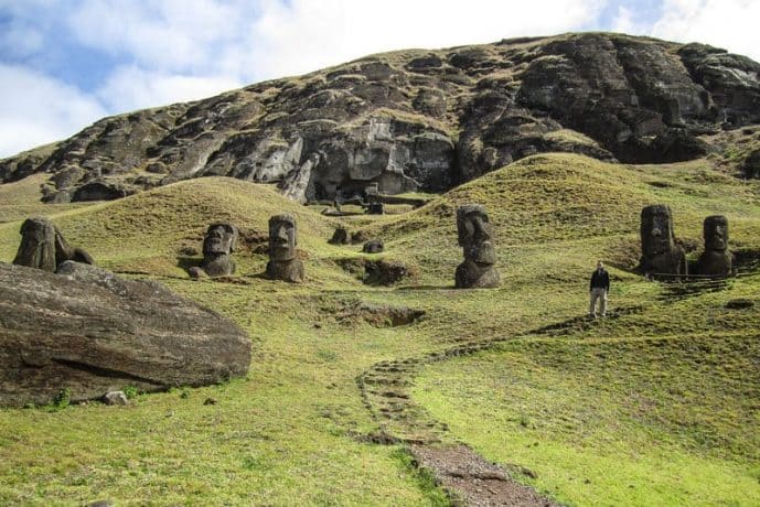 A path leads up to several Easter Island Moai heads.