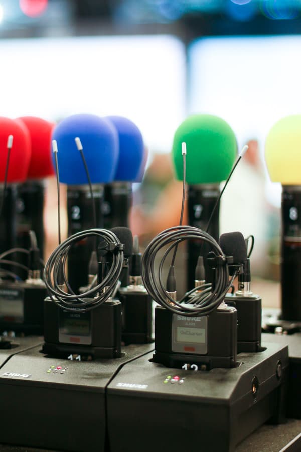 Speaker microphones charging in their stands.