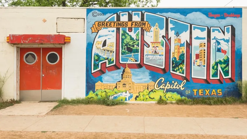 A large mural of the word "Austin", with landmarks of the capitol city inside the letters, and the Capitol building beneath.