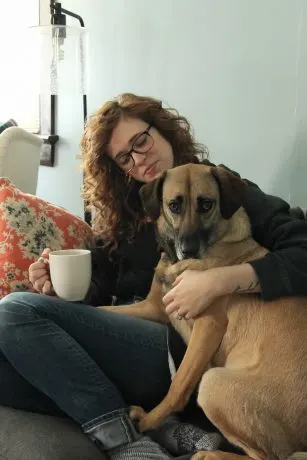 Stephie enjoying a cup of coffee with her dog, Anya.