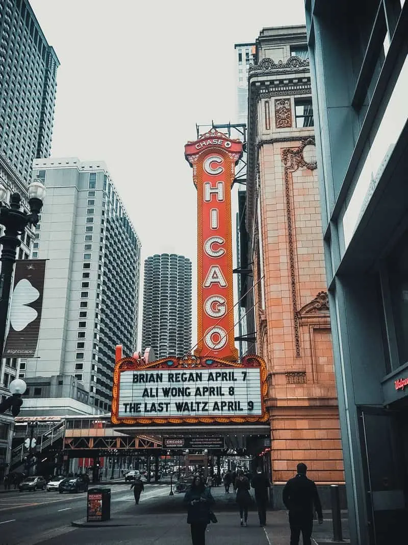 A large, lit-up sign reading "Chicago" over a theatre entrance.