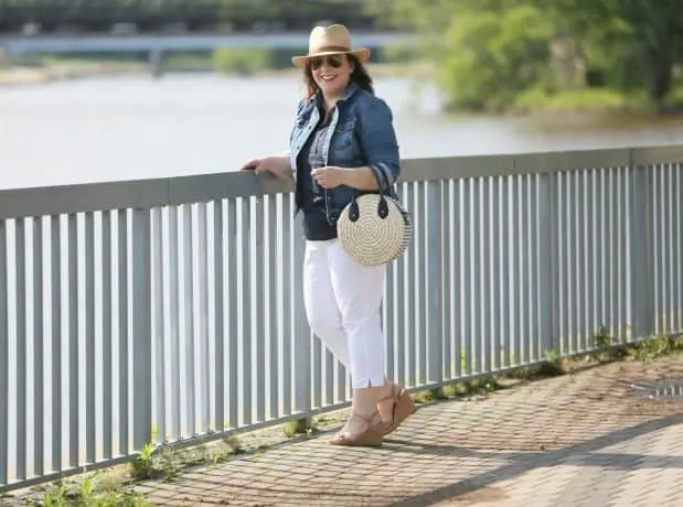Alison Gary stands at a railing, overlooking a river.