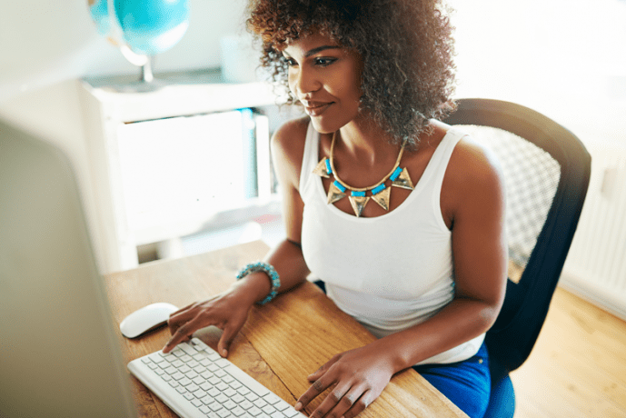 Woman blogging on a desktop computer