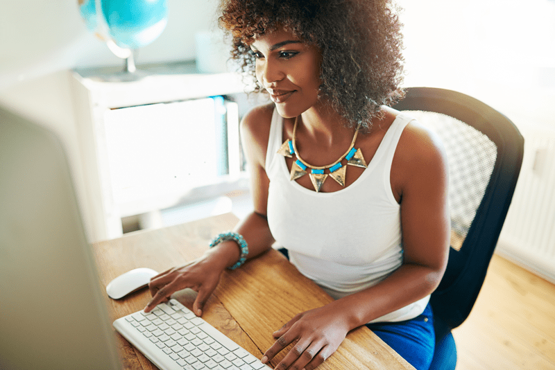 Woman blogging on a desktop computer