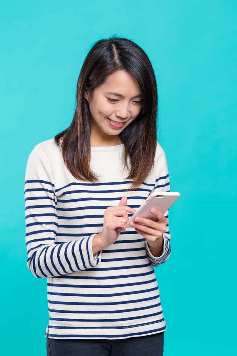 A woman uses a smartphone.