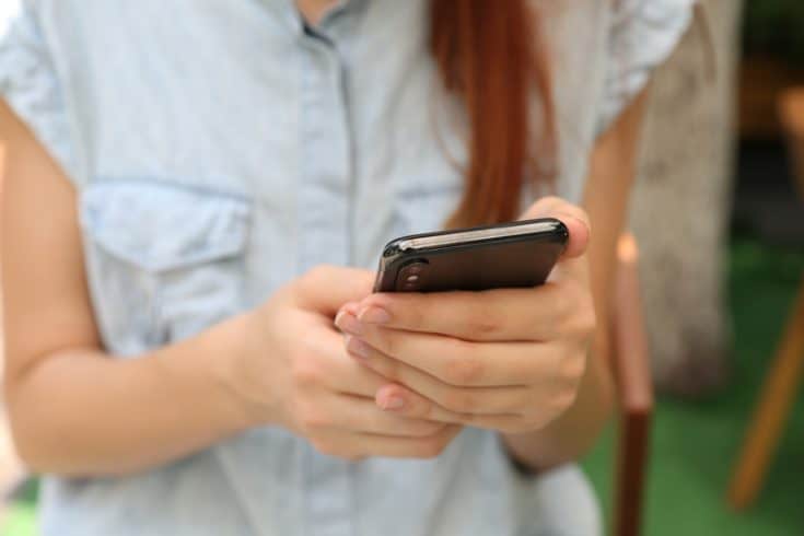 A woman using a smart phone.