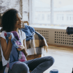 woman holding up clothing in front of a camera