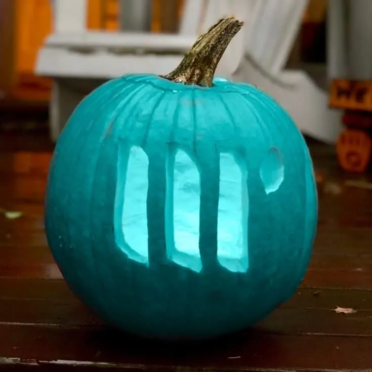 A teal pumpkin carved with the Mediavine logo.
