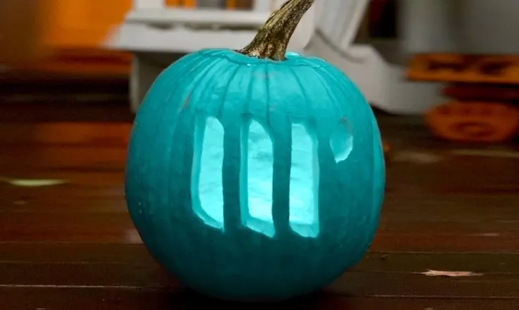 teal pumpkin with mediavine logo carved into it