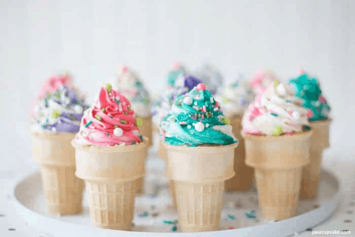Cupcakes baked in ice cream cones, topped with colorful frosting.
