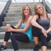sorey and kalee posing on stairs in fitness attire