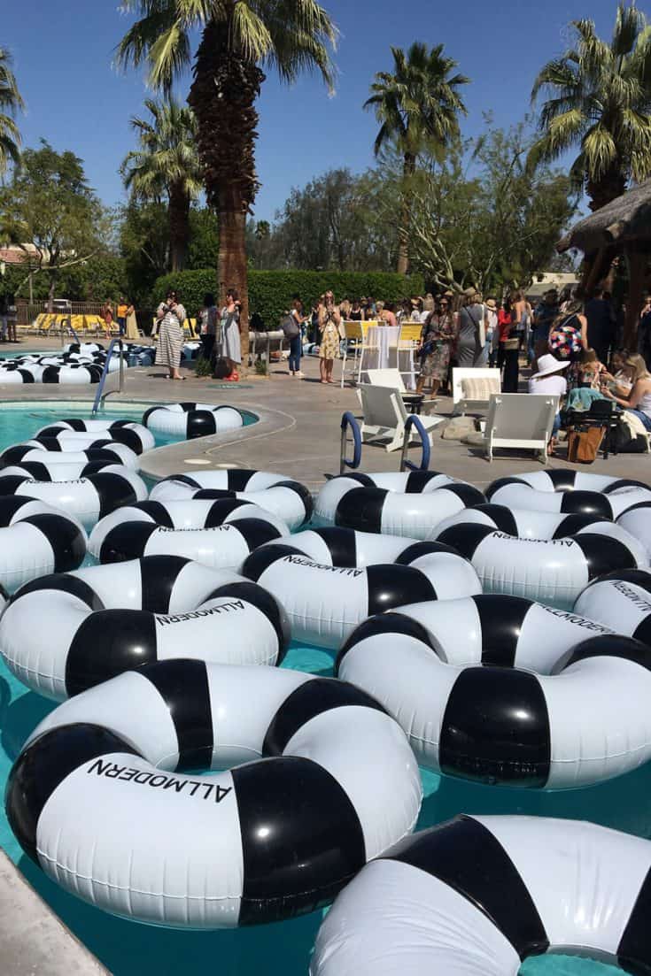 Black and white striped floats fill a lazy river style pool.