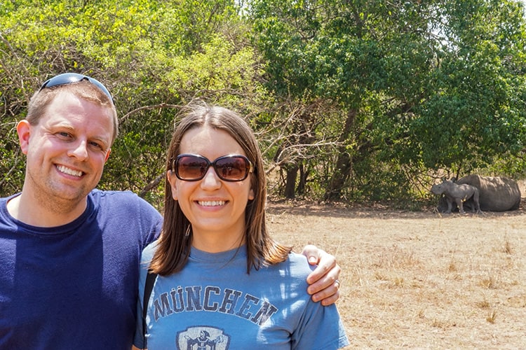 Jeremy and Angie from Living the Dream RTW with Rhinos in the background.