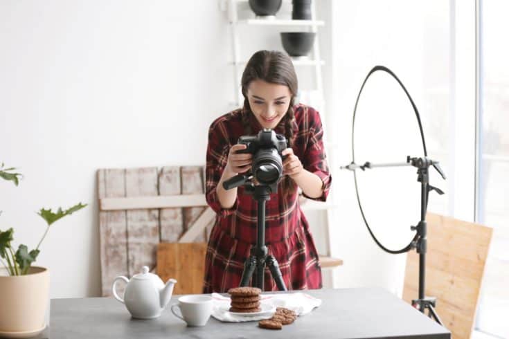 A woman taking photos of cookies.