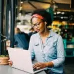 woman on laptop at a restaurant