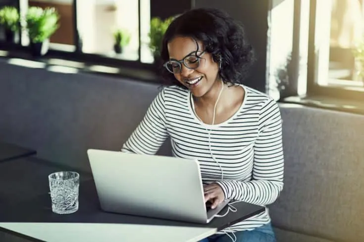 A woman using a laptop computer in a cafe.