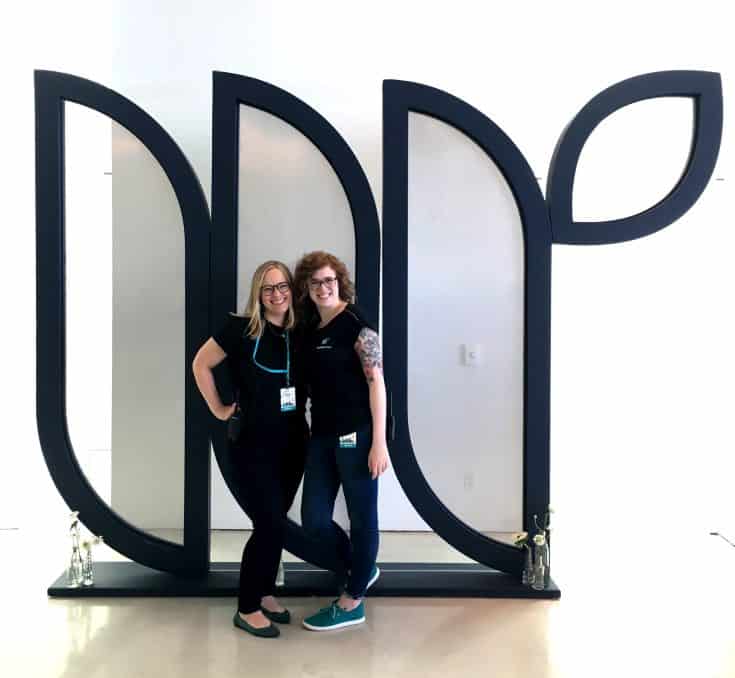 Mediavine employees Megan Myers and Stephie Predmore in front of the large Mediavine logo prop from the stage setup.