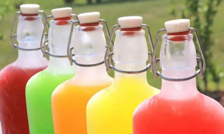 clear glass bottles filled with the colors of skittles