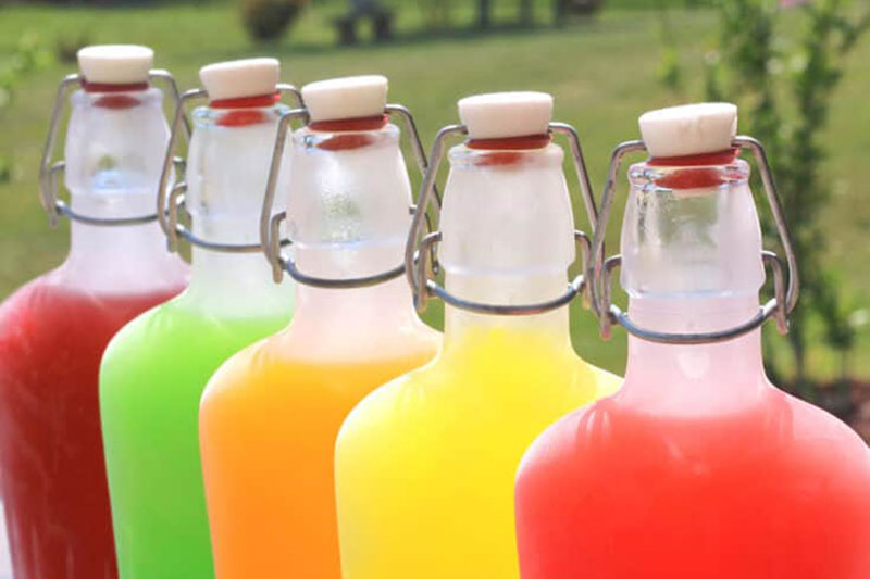 clear glass bottles filled with the colors of skittles