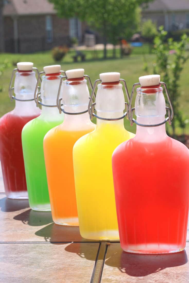Several different colored drinks in resealable bottles.