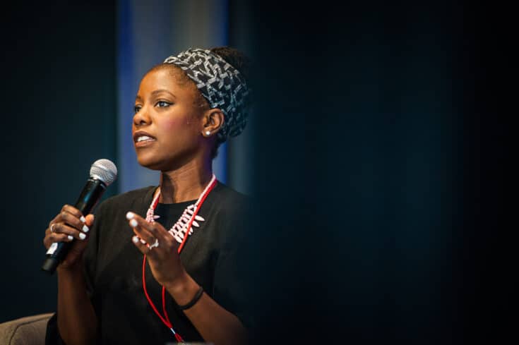 A speaker talks into a microphone at WITS.