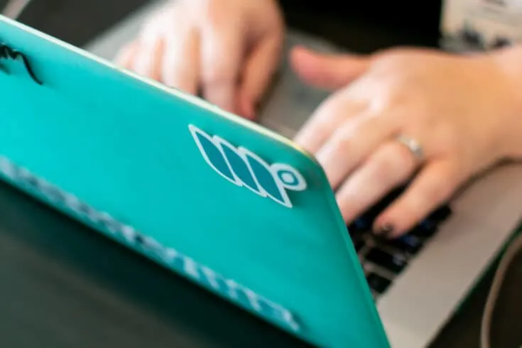 woman typing on a laptop to learn why Mediavine Publishers Grow Exponentially AFTER Joining