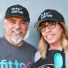Hilda and partner wearing fit to serve shirts and hats