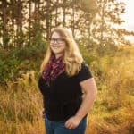 trista standing in a grass field