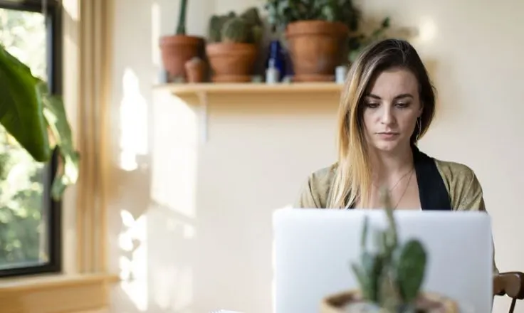 woman looking at computer in her office