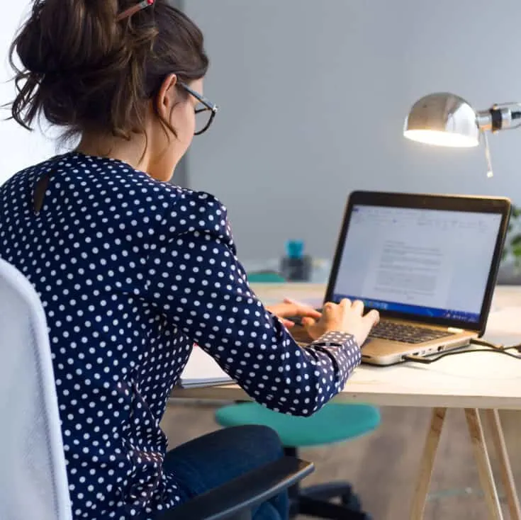 woman working on a laptop in a home office