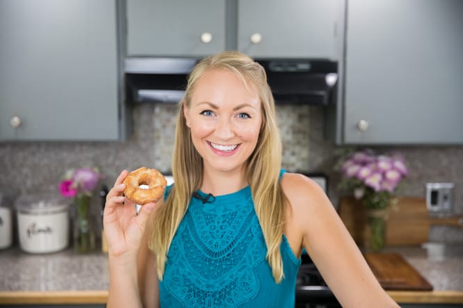 Sam of Sugar Spun Run holding a donut