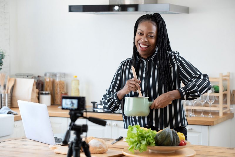 food blogger cooking in front of camera