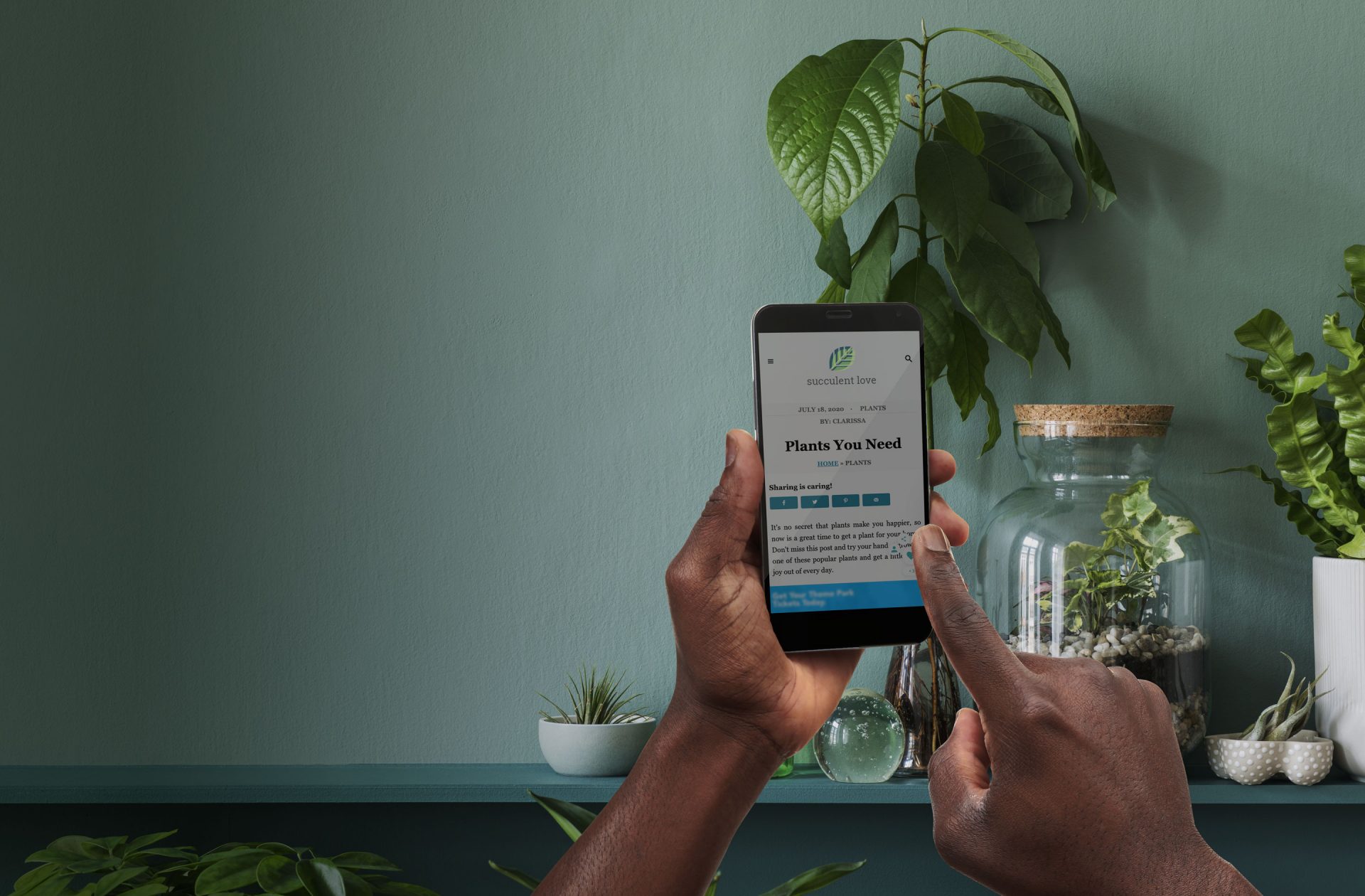 hands using grow on a website in a room full of plants