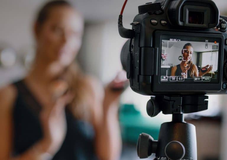 woman filming a video on a DSLR video camera