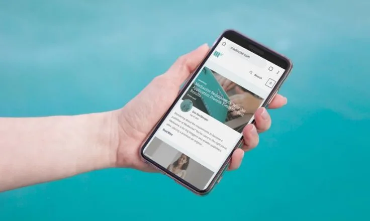 hand holding phone with mediavine website
