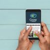 hands holding phone with grow logo and social icons