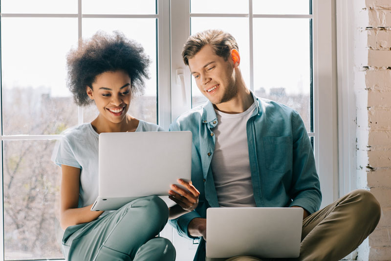 man and woman on laptops