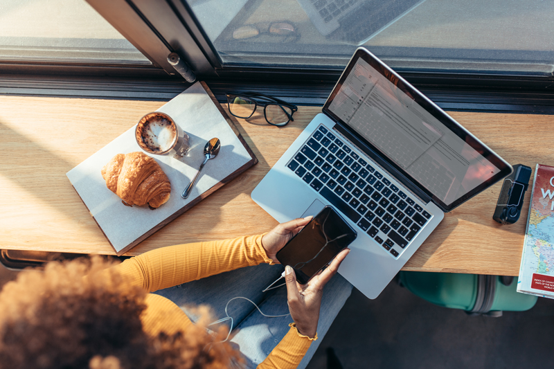 above view of woman on phone and laptop