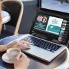 woman watching summer of live on laptop in a cafe