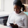 woman sitting on phone in lounge area