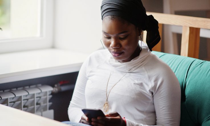 woman sitting on phone in lounge area