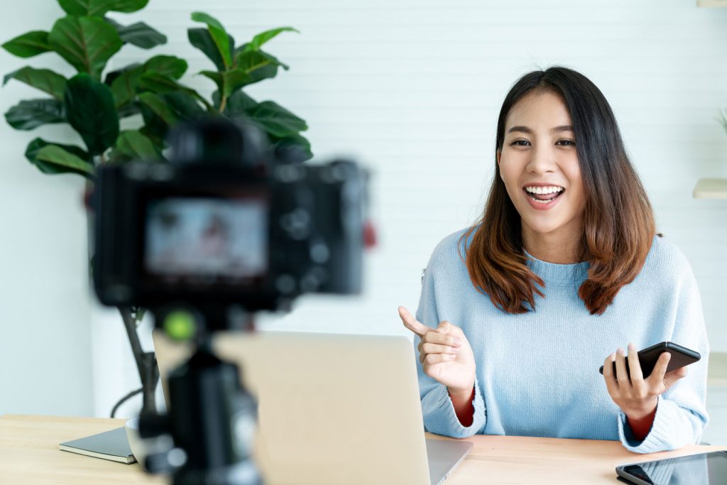 female vlogger filming a video from her desk