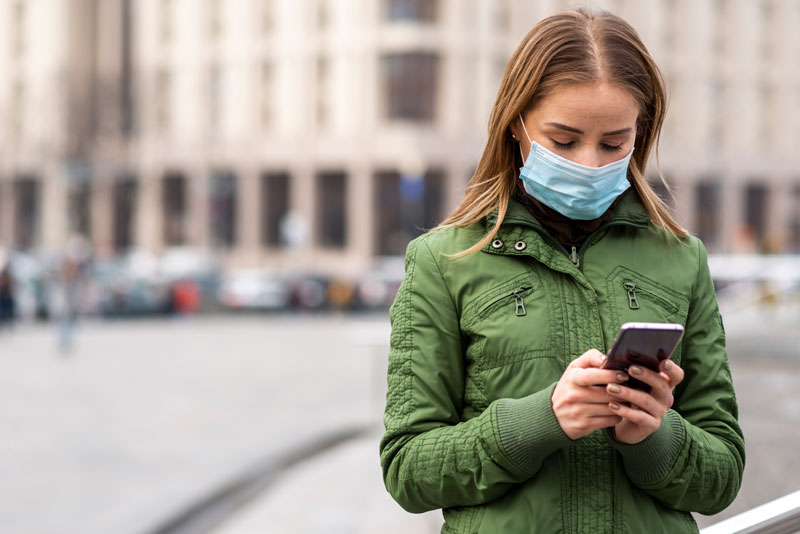 woman wearing mask on phone